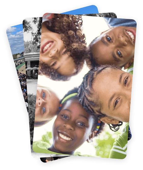 Close-up of five smiling children from diverse backgrounds, looking down at the camera. Blurred background keeps focus on their joyful faces.